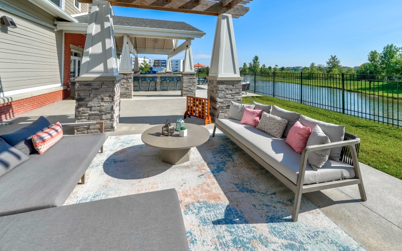 Outdoor lounge with seating facing fountain pond